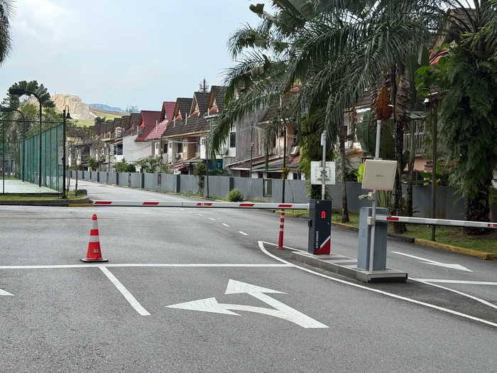RFID gate system with barrier arm at a gated residential community entrance for touchless access control by Gprop Systems.